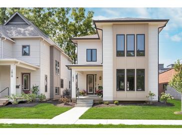 Beautiful modern home with eye-catching design, manicured lawn and inviting front porch at 1822 Central Ave, Indianapolis, IN 46202