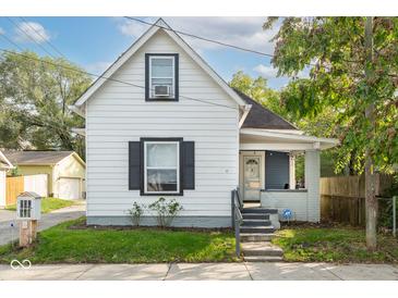 Charming white house with gray accents and a landscaped lawn at 2111 E St Clair St, Indianapolis, IN 46201