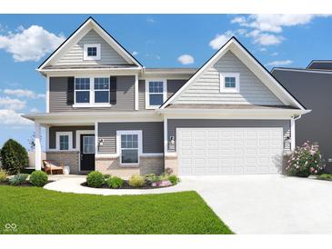 Charming two-story home with gray siding, brick accents, and a well-manicured lawn at 11614 Hartwell St, Indianapolis, IN 46235