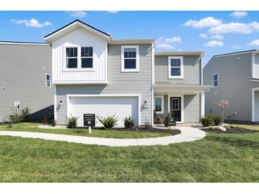 Charming two-story home with a manicured lawn, inviting entrance, and a two-car garage at 11626 Hartwell St, Indianapolis, IN 46235