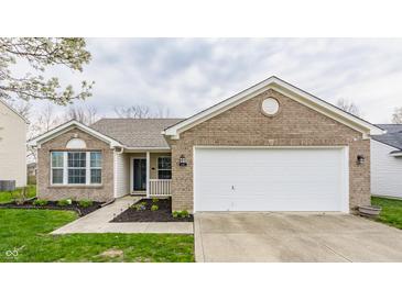 Charming single Gathering home with brick and siding, attached garage and freshly mulched landscaping at 1681 Copeland Farms Dr, Greenfield, IN 46140