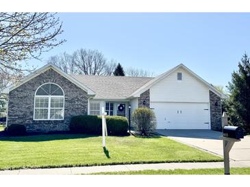 Charming single-story home featuring a well-manicured lawn and brick accents at 6615 Rushing, Noblesville, IN 46062