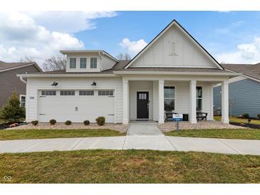 Charming one-story white home with a welcoming front porch and a well-manicured lawn at 19349 Sumrall Pl, Westfield, IN 46074