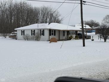 Ranch home with snow covered yard at 6720 N Michigan Rd, Fairland, IN 46126