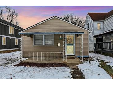 Charming bungalow with covered porch and snow-covered yard at 837 Birch Ave, Indianapolis, IN 46221