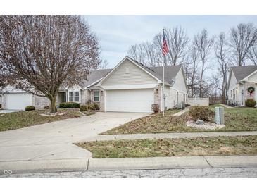 Brick ranch home with attached garage and American flag at 10832 Harness Way, Indianapolis, IN 46239