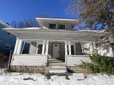 Gray house with front porch, freshly painted, needs landscaping at 1318 N Lasalle St, Indianapolis, IN 46201