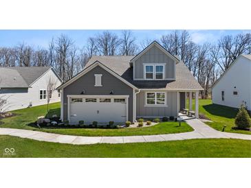 Charming two-story home with landscaped yard and a two-car garage in a suburban neighborhood at 19357 Sumrall Pl, Westfield, IN 46074