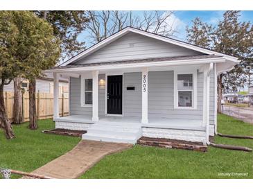 Charming gray home with well-maintained lawn and inviting front porch at 2005 E Maryland St, Indianapolis, IN 46201