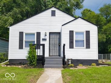 Charming single-story home featuring a white exterior, black shutters, and a well-maintained front yard at 3501 Caroline Ave, Indianapolis, IN 46218
