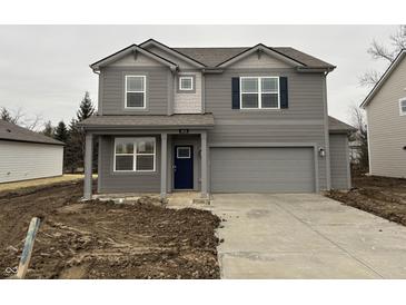 Two-story home featuring a covered porch, attached garage, and neutral gray siding at 5133 Cartland Dr, Indianapolis, IN 46239