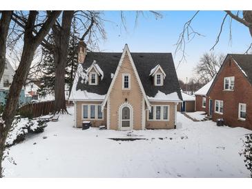 Tan two-story house with snow covered yard at 714 Berkley Rd, Indianapolis, IN 46208