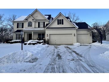 Two-story house with three-car garage, snow covered driveway, and basketball hoop at 8636 Sommerwood Dr, Noblesville, IN 46060