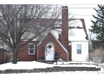 Brick and siding house with snow covered roof and yard at 906 Raible Ave, Anderson, IN 46011