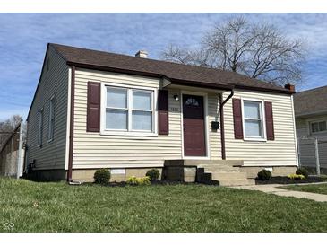Charming home featuring a well-manicured lawn, vinyl siding, and delightful curb appeal at 1612 E Raymond St, Indianapolis, IN 46203