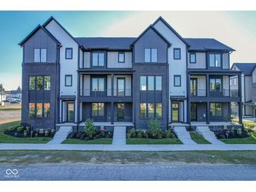 Modern townhomes with brick and siding facade, black trim, and small front gardens at 373 S Cherry St, Westfield, IN 46074