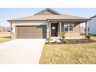 Charming single-story home with a two-car garage, covered porch, and freshly landscaped front yard at 9236 Kavanaugh Dr, Indianapolis, IN 46239