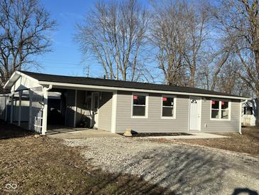 Newly renovated ranch home with gray siding, and a carport at 1054 Center St, Martinsville, IN 46151