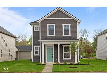 Charming two-story home with gray siding, white trim, a quaint porch and lush green lawn at 1713 Real St, Indianapolis, IN 46240