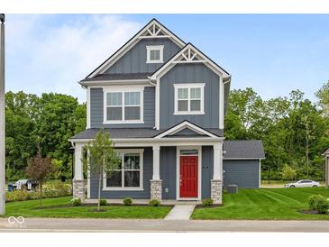 Charming two-story home with a red front door, gray siding, white trim, and manicured lawn at 1721 Real St, Indianapolis, IN 46240