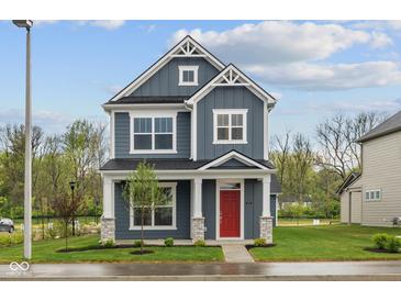 Charming two-story home featuring a striking red door, stone accents, and beautiful curb appeal at 1721 Real St, Indianapolis, IN 46240