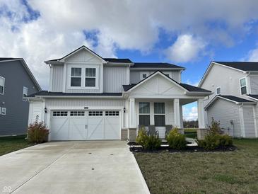Two-story house with gray siding, white trim, and a two-car garage at 3406 Preakness St, Whitestown, IN 46075