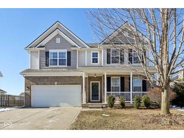 Two-story house with brick and siding exterior, attached garage, and front porch at 3460 Limelight Ln, Whitestown, IN 46075