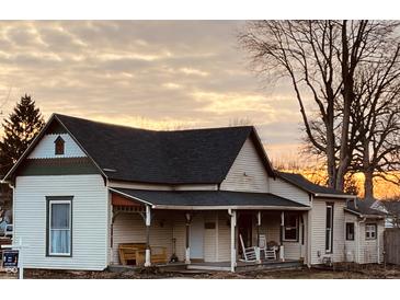 Charming 1-story home with a wrap-around porch and unique architectural details at 704 S Ohio St, Sheridan, IN 46069