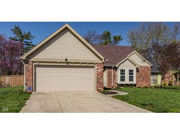 Charming brick and siding home featuring a two-car garage and well-maintained lawn at 8104 Pocket Hollow Ct, Indianapolis, IN 46256