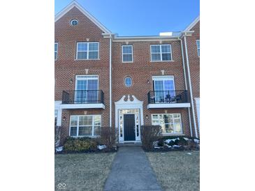 Brick front exterior of townhome with walkway and landscaping at 15365 Mystic Rock Dr, Carmel, IN 46033