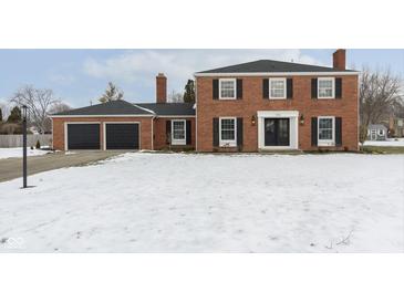 Brick house with 2-car garage and snow-covered lawn at 1716 Westwood Dr, Anderson, IN 46011