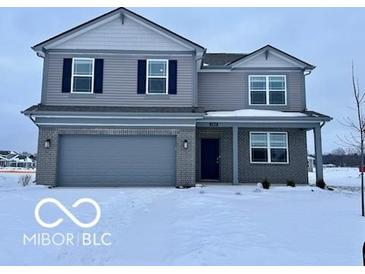 Two-story house with gray siding, a gray door, and a three-car garage at 2349 Granby Dr, Whitestown, IN 46075