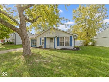 Cute ranch home with blue shutters and a spacious yard at 5617 Yucatan Dr, Indianapolis, IN 46237