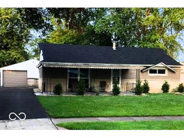 Charming single story home with a well-manicured front yard, large trees, and asphalt driveway at 604 Gooseberry Ln, Greenwood, IN 46143