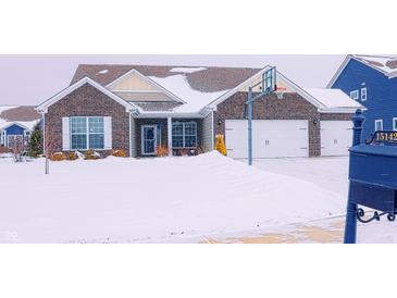 Brick home with attached garage and basketball hoop, snow covered yard at 15142 Blue Ribbon Blvd, Fishers, IN 46040