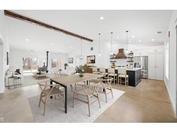 Bright, open concept living space featuring a modern kitchen, dining area, and inviting living room with high ceilings at 1600 S Morgantown Rd, Morgantown, IN 46160