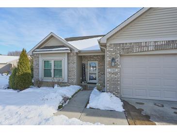 Two-car garage and front entryway with a welcome sign at 2367 Heartland Ln, Brownsburg, IN 46112