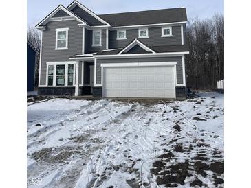 Charming two-story home featuring gray siding, white trim, and an attached two-car garage at 250 Ambassador Dr, Pittsboro, IN 46167