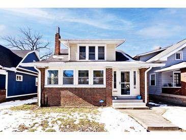 Brick home with a charming front porch and well-manicured lawn at 426 N Euclid Ave, Indianapolis, IN 46201