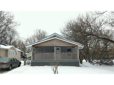 Cozy bungalow with wood accents and a covered porch at 6029 English Ave, Indianapolis, IN 46219