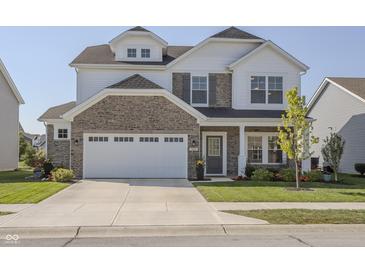 Charming two-story home featuring a stone facade, attached two-car garage, and manicured front yard at 1001 Parker Ln, Westfield, IN 46074