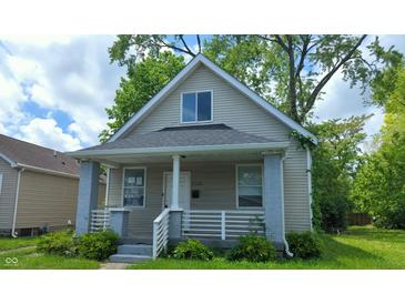 Inviting front view of home, showcasing its charming architecture and well-maintained exterior with front porch at 1128 N Holmes Ave, Indianapolis, IN 46222