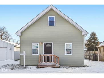 Gray house with wooden steps and snowy yard at 1418 S New Jersey St, Indianapolis, IN 46225