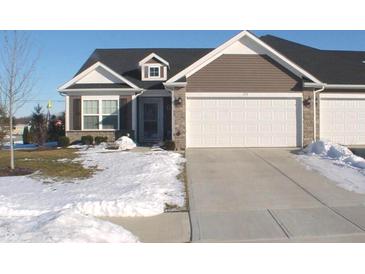 Exterior of charming ranch home with two-car garage and snow-covered lawn at 173 Megan Way, Cumberland, IN 46229