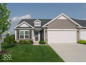 Charming single-story home with a well-manicured lawn, attached garage, and classic architectural details at 173 Megan Way, Cumberland, IN 46229