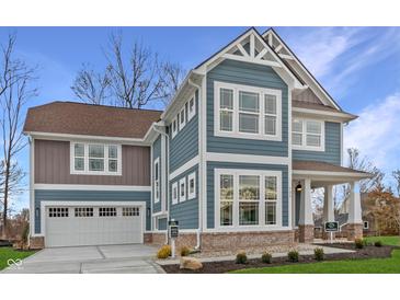 Charming two-story home with blue siding, white trim, and a two-car garage at 1837 Luther St, Indianapolis, IN 46203