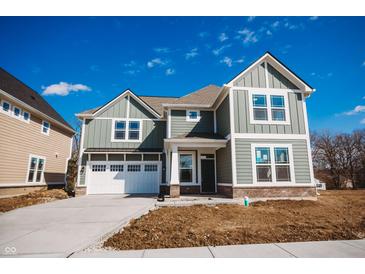 Charming two-story home with a two car garage and a well-lit porch at 1902 Zwingley St, Indianapolis, IN 46203