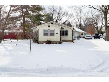 Quaint ranch home with snow covered yard at 2515 Fairfax Rd, Indianapolis, IN 46227
