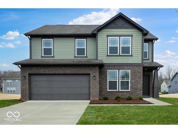 Beautiful two-story home features a brick and siding exterior, a two-car garage, and a well-manicured lawn at 4767 E Shadowbrook Dr, Camby, IN 46113