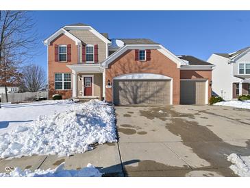 Brick two-story home with attached two-car garage and snowy front yard at 676 Pigeon Dr, Brownsburg, IN 46112